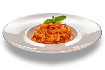 Tagliatelle noodles pasta with red tomato sauce with basil leaves in white plate isolated