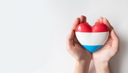 手で持っているルクセンブルクの国旗のハート(Heart of Luxembourg flag held in hand.)
