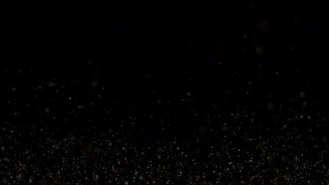 4K Explosion of Golden Bokeh lights. Holiday motion background. Glowing particle abstract. 2160p 60fps. Exploding gold particles. 3d rendering. Isolated on black effect. 2025 Trend footage. Rain