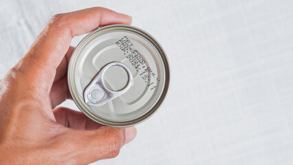 Hand Holding a Can with Pull Tab