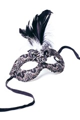 black mask with lace and feathers on a white background