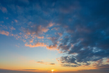 Glowing real sky at sunset texture background overlay. Dramatic red and orange clouds.