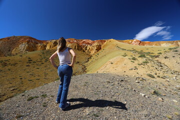 Altai Republic. Tourists pose against the background of Martian and Moon landscapes – deserted area with canyons.