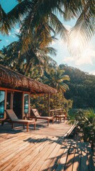 A tropical hut with a wooden deck and lounge chairs overlooking a lush green hillside.  The sun shines brightly through the palm trees.