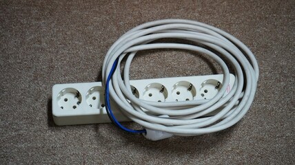 Old electric extension cable on floor