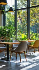 Obraz premium Bright, inviting interior of a modern cafe with lush greenery and stylish furniture, perfect for relaxation or remote work.