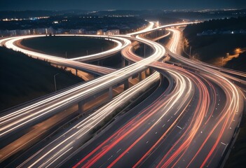 Obraz premium Long exposure of a busy highway at night with blurred car lights creating a swirling pattern