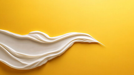 Creamy white texture flowing on vibrant yellow background creates striking visual contrast. smoothness and fluidity evoke sense of elegance and simplicity