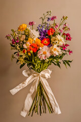Fototapeta premium Beautiful bouquet with a white ribbon elegantly wrapped around the stems.