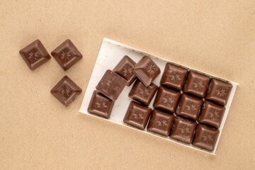 Dark chocolate  on kraft paper, macro, top view.