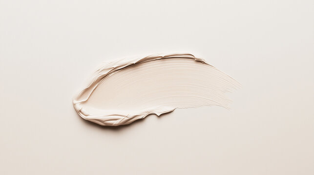 a luxurious swatch of light beige concealer on a flawless white canvas