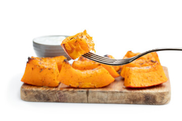 Roasted pumpkin slices with herbs isolated on white