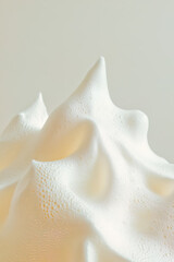 Mound of shaving foam, sculpted into a smooth, fluffy peak.