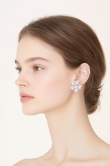 Fototapeta premium Elegant Portrait of a Woman with Flower Earrings and Glossy Lips