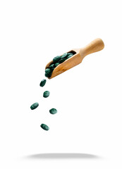 Spirulina dietary supplement tablets close-up isolated on white background. Biohacking. Dietary supplement tablets. Falling spirulina tablets. Cyanobacteria in tablets.