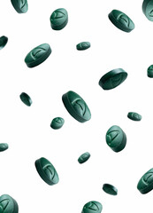 Spirulina dietary supplement tablets close-up isolated on white background. Biohacking. Dietary supplement tablets. Falling spirulina tablets. Cyanobacteria in tablets.