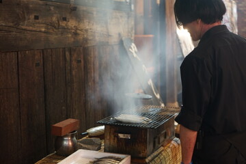 japanese man cooking sardines