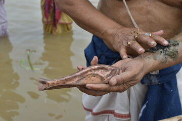 Tarpan is being performed by Indian hindu devotees on the banks of the holy river Ganga in Kolkata, India. In Hindu mythology this day is also called Mahalaya.