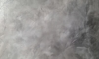 Naklejka premium A close-up shot of a textured grey concrete wall, with subtle light and dark variations creating an abstract pattern.