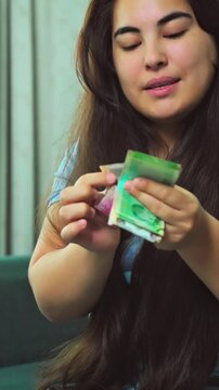 Woman counting QAR or Riyals of Qatar, issued by Central bank of Qatar,. High quality 4k footage