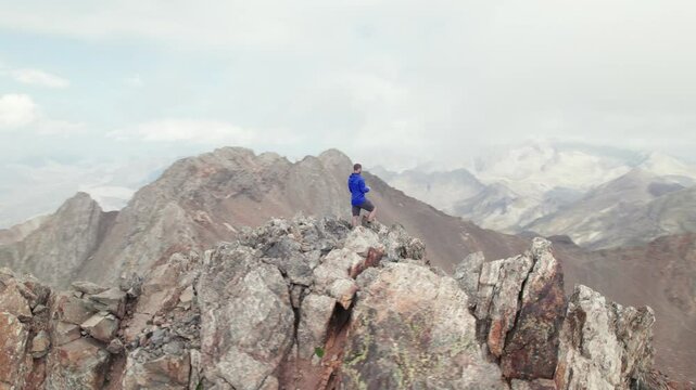 Trekking to Pico Argualas and Algas in 4K: Mountaineers climbing, with views of Garmo Negro and Los Infiernos, captured from drone in an impressive day in the Aragonese Pyrenees.