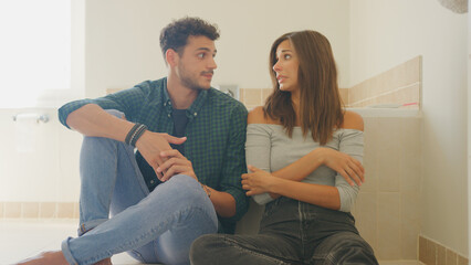 Couple Waiting Anxiously For Result Of Home Pregnancy Test In Bathroom © Monkey Business