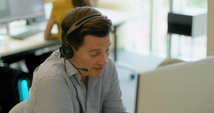 Business Man with Headset on a Video call in an Office, Telemarketing, Call centre