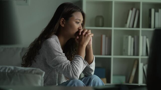 Young Asian woman sitting in a bedroom, feeling sad tired and worried suffering depression in mental health. in concept of depression anxiety and insomnia