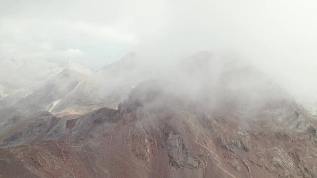 Mountaineers ascending Argualas and Algas Peak with views of Garmo Negro and Los Infiernos: 4K aerial capture of a trekking day in Panticosa Valley, Aragonese Pyrenees.