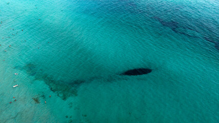 Aerial view of people bathing in the ocean.