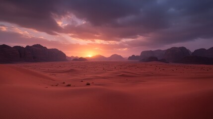 Fototapeta premium A low-angle view captures a vast desert landscape at sunset, showcasing reddish sand dunes and jagged rocks beneath a colorful sky, with long shadows captivating the scene