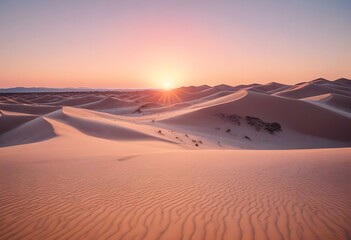 A large pink sun setting over dark sand dunes in a desert landscape