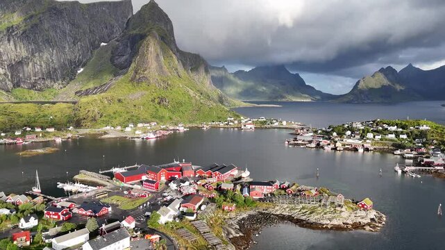 Aerial Drone Views of Reine, Colorful Mountains and Cottages in Spring in the Lofoten Islands, Norway. Rainbow drone footage in 4K.