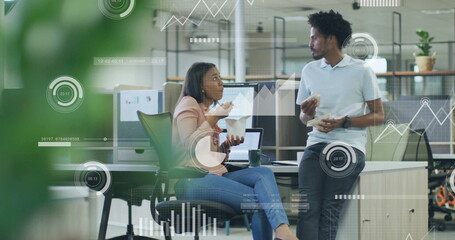 Image of financial data processing over diverse colleagues discussing work in office