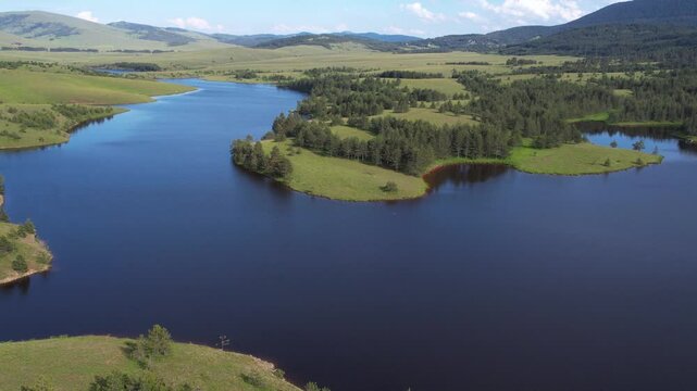 Drone Shot of Lake, Green Meadows and Forest in Idyllic Mountain Landscape. Zlatibor Serbia