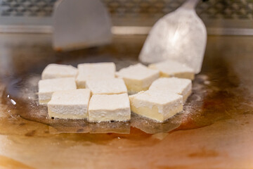 The fragrant Teppanyaki tofu is being prepared for each dish