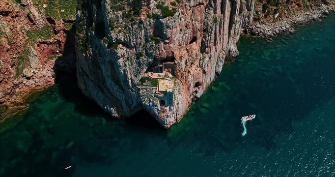 Tilt pan shot of Porto Flavia in Sardinia, Italy