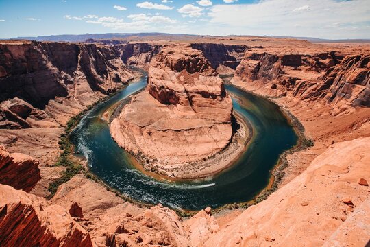 Horseshoe-shaped bend in a river surrounded by towering canyon w