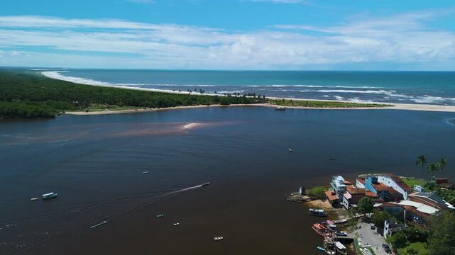 Aerial view following a boat driving on the coast of Itacare, sunny day in Brazil