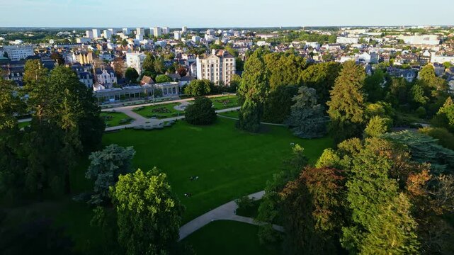 Descending aerial movement to the Parc du Thabor's huge parkside, Rennes, France.
