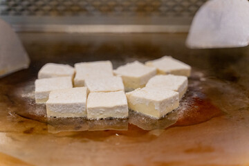 The fragrant Teppanyaki tofu is being prepared for each dish
