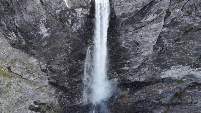 Epic waterfall in clouds zoom out drone shot, double waterfall of Mardalsfossen in Norway in 4K.