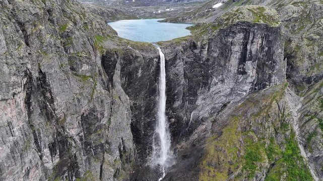 Epic waterfall in clouds zoom out drone shot, double waterfall of Mardalsfossen in Norway in 4K.
