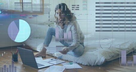 Image of financial data processing over biracial woman using laptop
