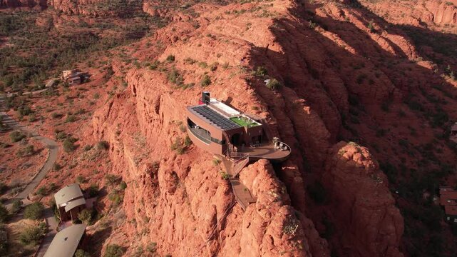 Drone Shot of Futuristic House With Solar Panels Atop of Cliff in Landscape of Sedona Arizona USA