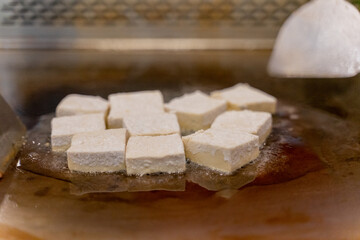 The fragrant Teppanyaki tofu is being prepared for each dish