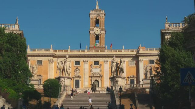 Visitors admire gorgeous views and historic architecture atop Capitoline Hill on a sunny day