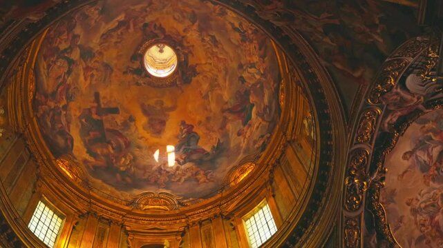 Experience the stunning artistry of a dome adorned with vibrant frescoes and natural light in Church of the Gesu