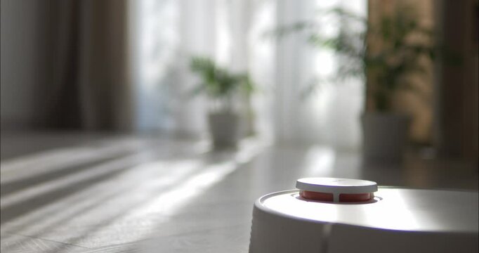 The robot vacuum cleaner travels around the room in the house and picks up dust.