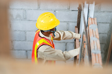 Construction worker  inspects and checking construction standards at the site.